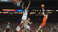 Illinois Fighting Illini guard Andrej Stojakovic (2) shoots against Connecticut Huskies guard Silas Demary Jr. (2) in the second half during a semifinal of the Final Four of the men's 2026 NCAA Tournament at Lucas Oil Stadium.
