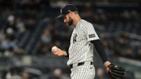 New York Yankees pitcher Jake Bird (59) reacts after surrendering consecutive walks to load the bases against the Miami Marlins during the eighth inning at Yankee Stadium