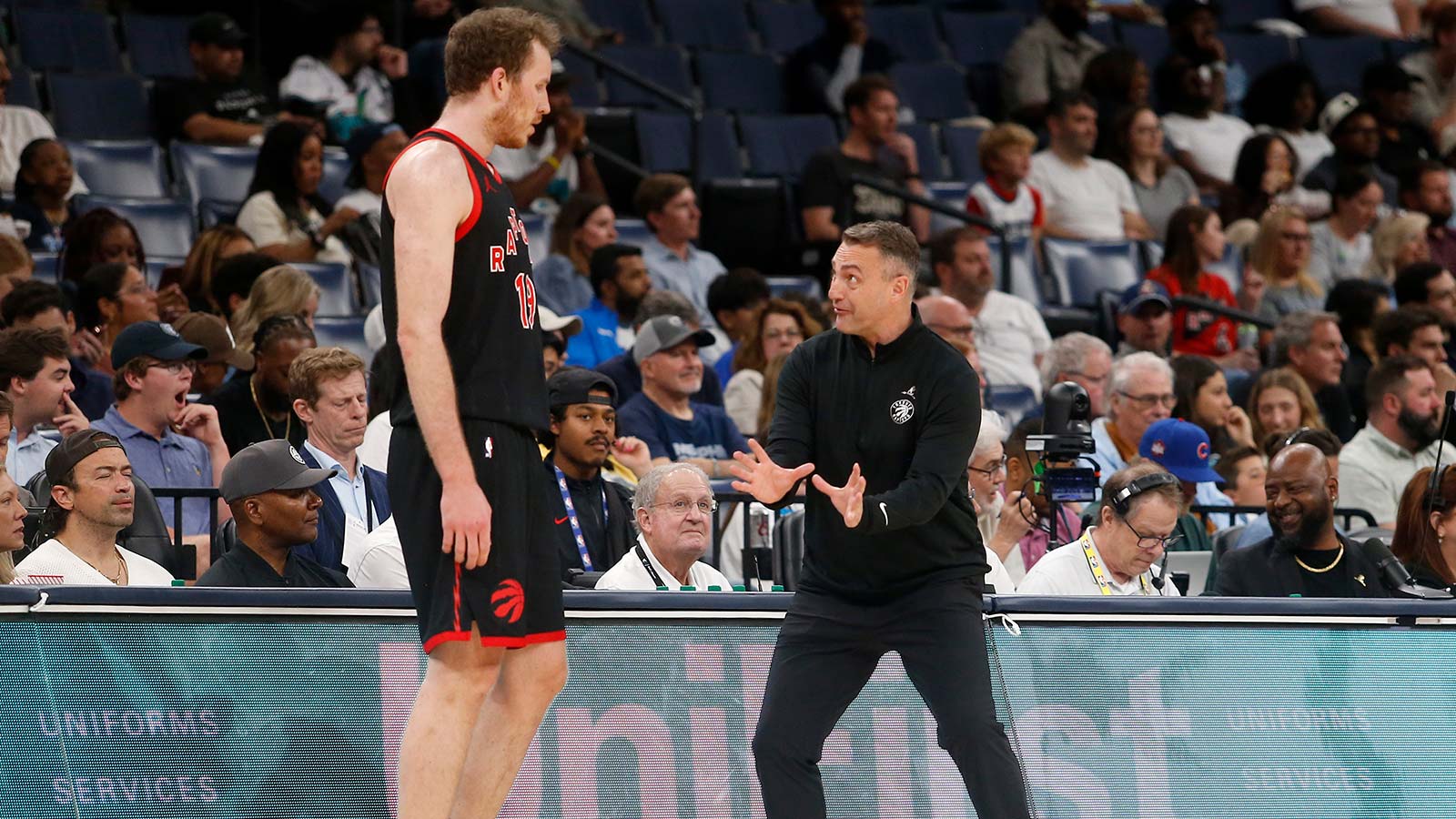 https://wp.clutchpoints.com/wp-content/uploads/2026/04/Jakob-Poeltl-and-Darko-Rajakovic-during-Raptors-game.jpg