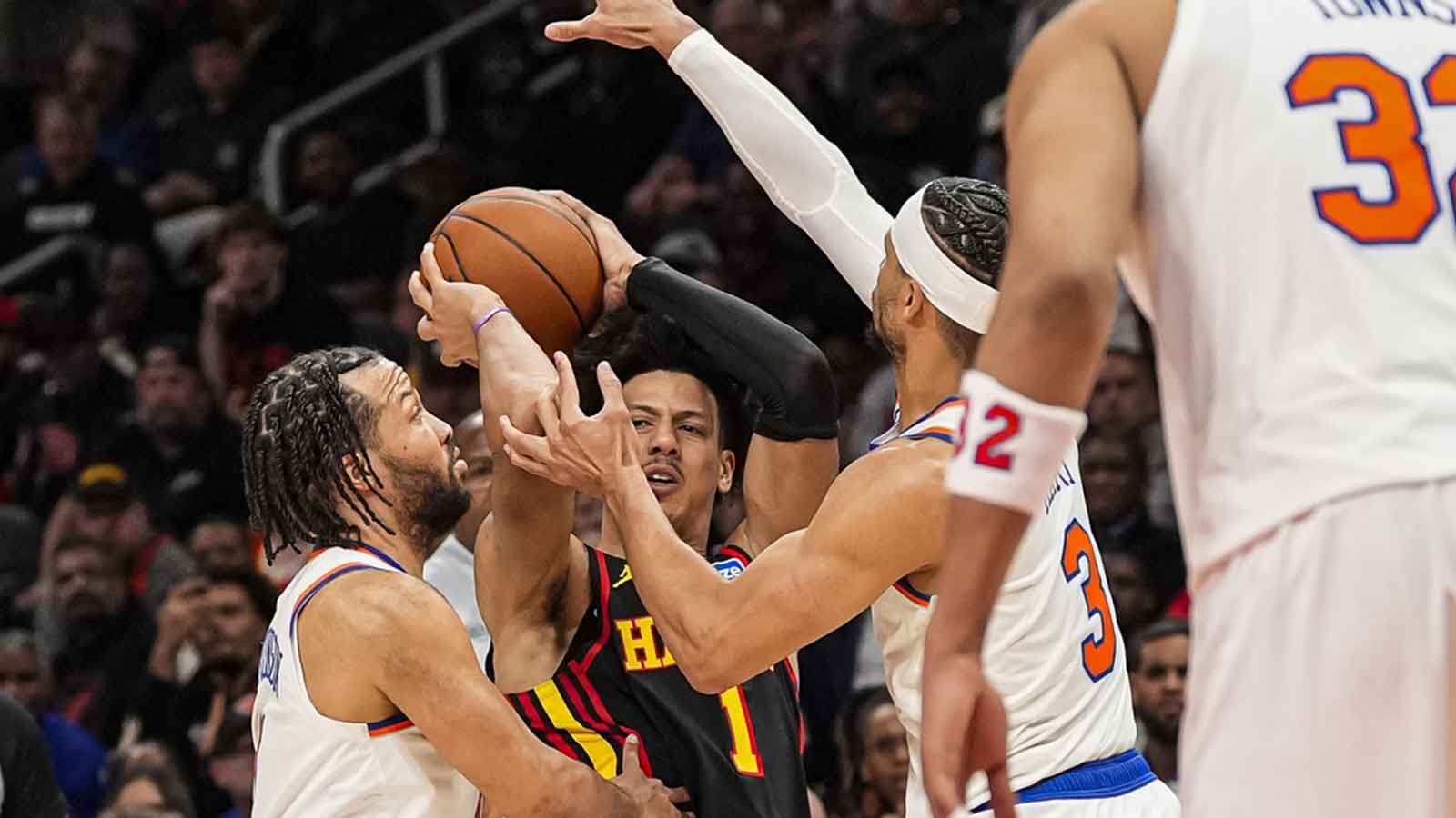 Atlanta Hawks forward Jalen Johnson (1) tries to pass between New York Knicks guard Jalen Brunson (11) and guard Josh Hart (3) during the second half at State Farm Arena. 