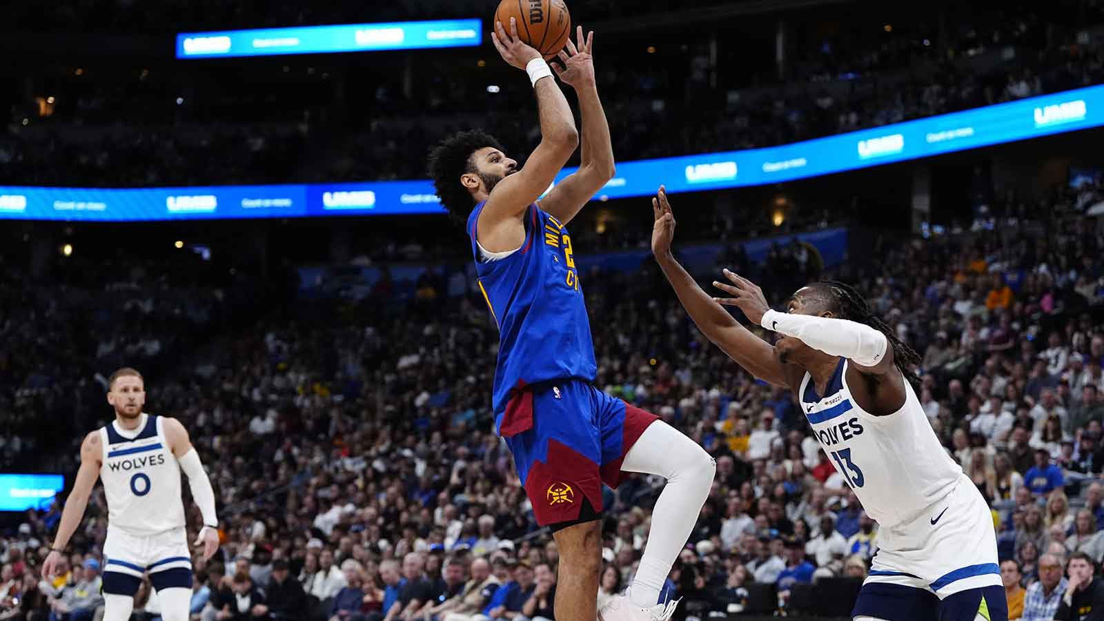 Denver Nuggets guard Jamal Murray (27) shoots the ball over Minnesota Timberwolves guard Ayo Dosunmu (13) in the second half at Ball Arena.