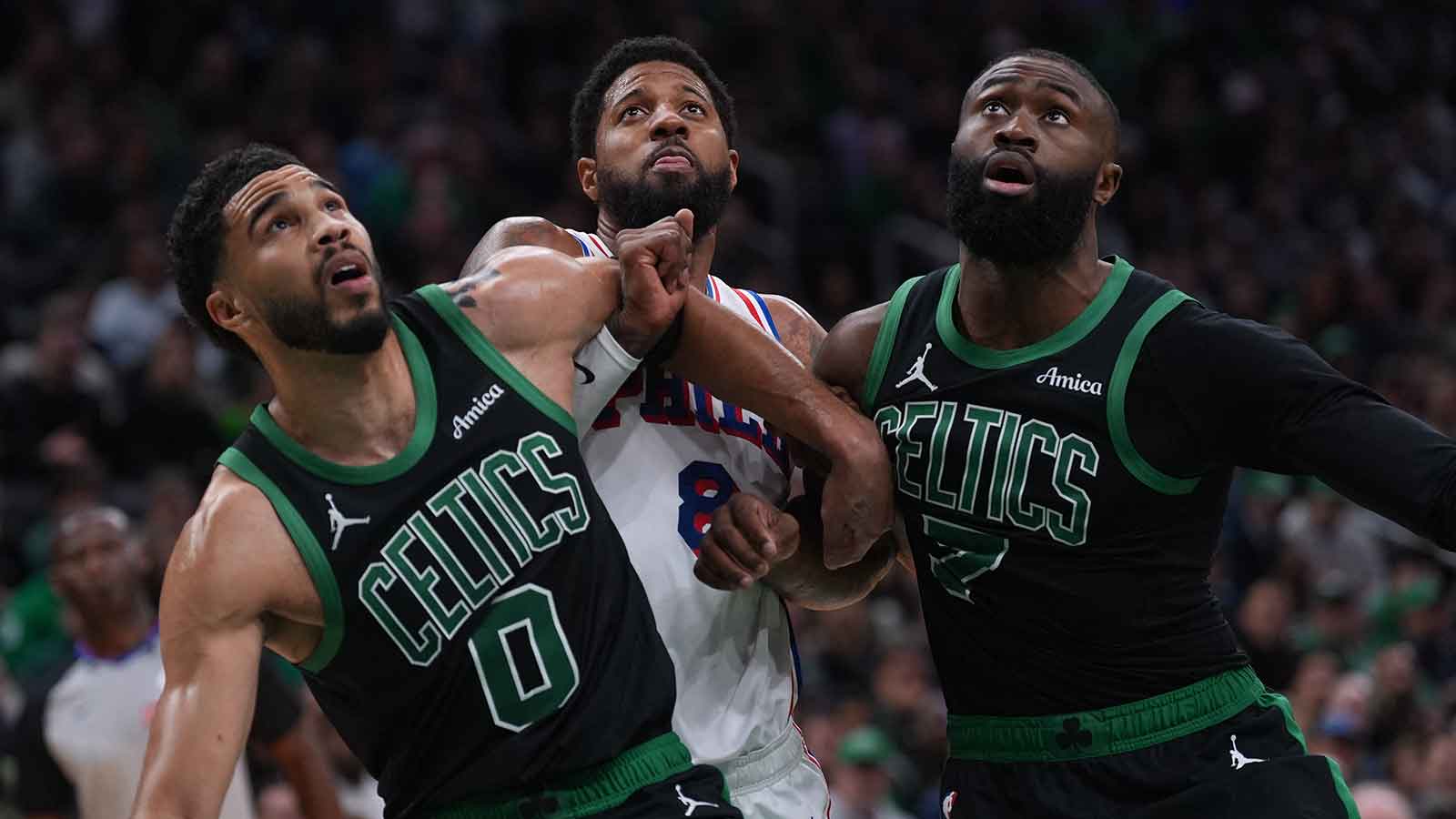 Boston Celtics forward Jayson Tatum (0) and guard Jaylen Brown (7) look for the rebound against Philadelphia 76ers forward Paul George (8) in the second quarter during game five of the first round of the 2026 NBA Playoffs at TD Garden.