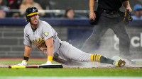 Athletics second baseman Jeff McNeil (22) slides into home plate to score against the Toronto Blue Jays during the seventh inning at Rogers Centre.