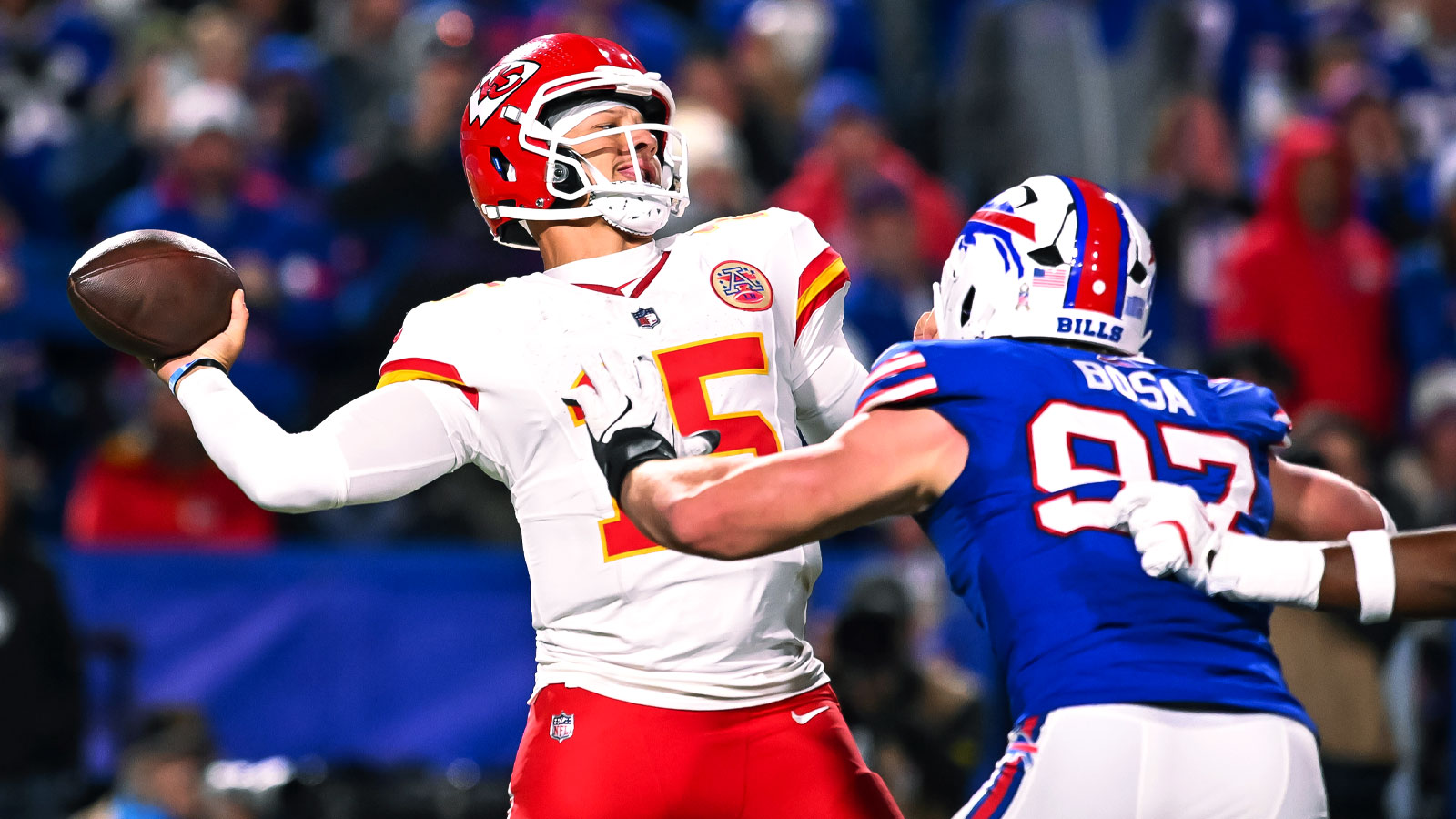 Kansas City Chiefs quarterback Patrick Mahomes (15) throws a pass under pressure from Buffalo Bills defensive end Joey Bosa (97) in the fourth quarter at Highmark Stadium