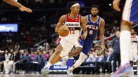 Washington Wizards guard Tre Johnson (12) drives to the basket past Philadelphia 76ers forward Paul George (8) in the second half at Capital One Arena.
