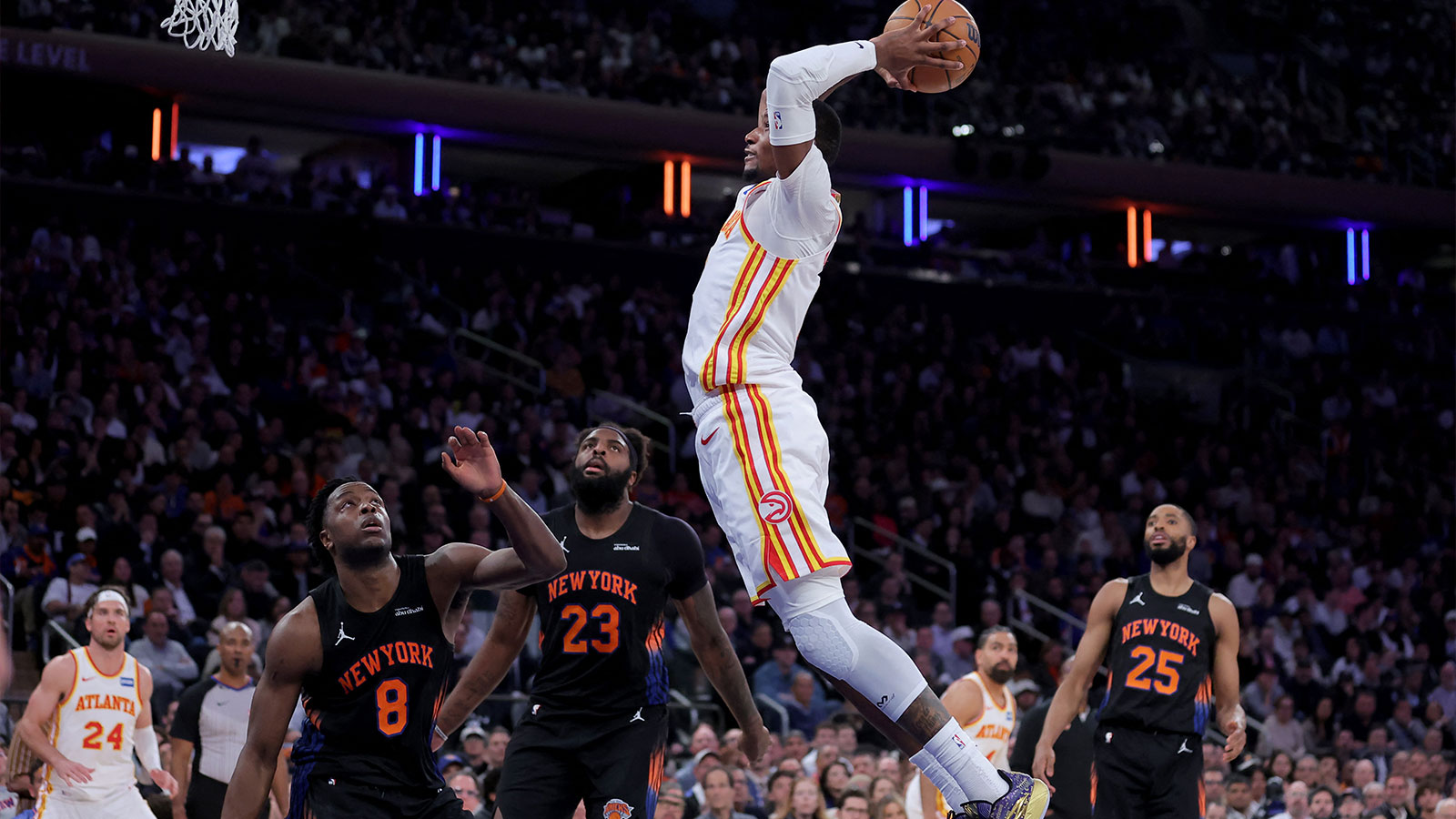 Atlanta Hawks forward Jonathan Kuminga (0) dunks against New York Knicks forward OG Anunoby (8) and center Mitchell Robinson (23) and guard Mikal Bridges (25) during the fourth quarter of game two of the first round of the 2026 NBA Playoffs at Madison Square Garden.