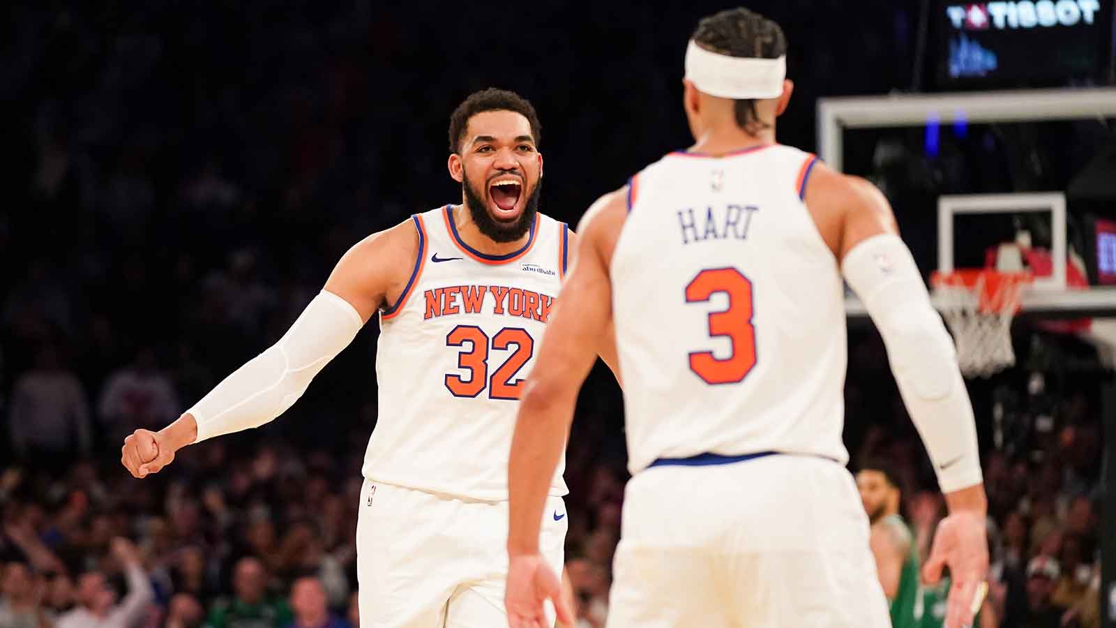 New York Knicks center Karl-Anthony Towns (32) celebrates with New York Knicks guard Josh Hart (3) after Hart hit a three pointer late in the fourth quarter against the Boston Celtics at Madison Square Garden.