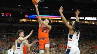 Illinois Fighting Illini guard Keaton Wagler (23) shoots against the Connecticut Huskies in the second half during a semifinal of the Final Four of the men's 2026 NCAA Tournament at Lucas Oil Stadium.