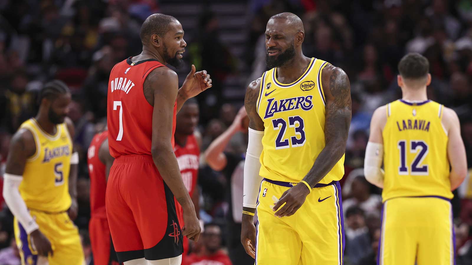 Houston Rockets forward Kevin Durant (7) talks with Los Angeles Lakers forward LeBron James (23) on the court during the second quarter at Toyota Center.