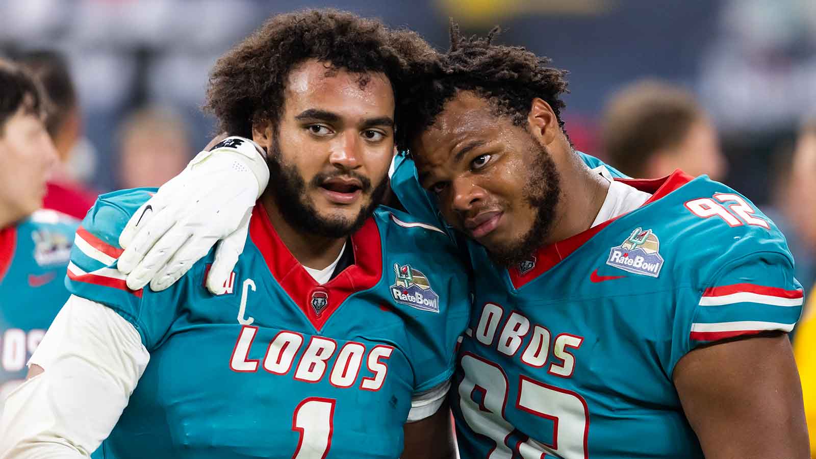 New Mexico Lobos defensive end Keyshawn James-Newby (1) and defensive tackle Brian Booker (92) react as they walk off the field after losing in overtime to the Minnesota Gophers during the Rate Bowl at Chase Field.