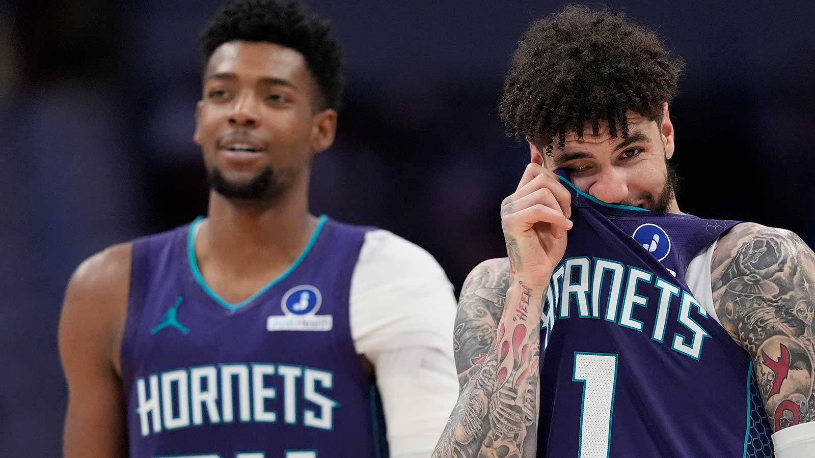 Charlotte Hornets guard LaMelo Ball (1) and forward Brandon Miller (24) watch a free throw attempt during the second half against the Indiana Pacers at Spectrum Center.