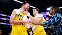Lakers guard Luka Doncic (77) reacts with guard Austin Reaves (15) after scoring a game winning shot during overtime against the Denver Nuggets at Crypto.com Arena
