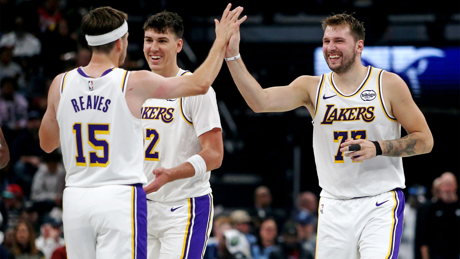 Lakers guard Luka Doncic (77) reacts with guard Austin Reaves (15) during a timeout during the second quarter against the Memphis Grizzlies at FedExForum