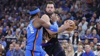 Lakers guard Luka Doncic (77) drives to the basket