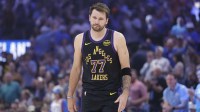 Lakers guard Luka Doncic (77) walks across the court