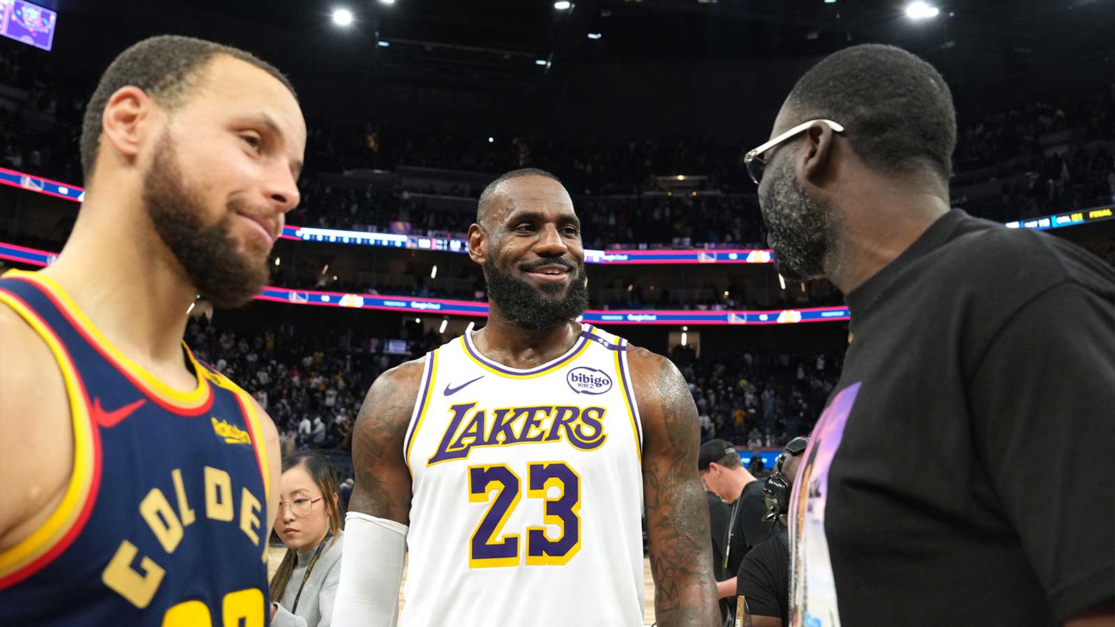 Los Angeles Lakers forward LeBron James (23) talks with Golden State Warriors guard Stephen Curry (30) and forward Draymond Green (right) after the game at Chase Center.