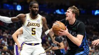 Dallas Mavericks forward Cooper Flagg (32) looks to shoot as Los Angeles Lakers center Deandre Ayton (5) defends during the first half at American Airlines Center.