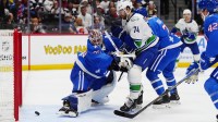 Vancouver Canucks left wing Jake DeBrusk (74) scores on Colorado Avalanche goaltender MacKenzie Blackwood (39) in the first period at Ball Arena.