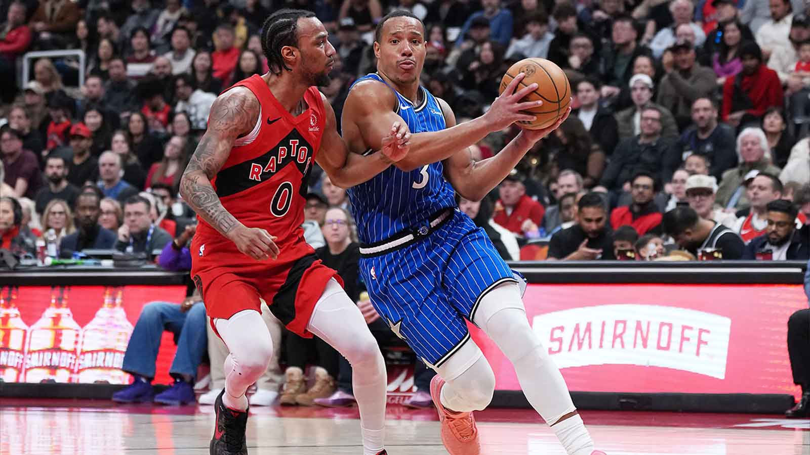 Magic guard Desmond Bane (3) controls the ball as Toronto Raptors guard A.J. Lawson (0) tries to defend during the second quarter at Scotiabank Arena