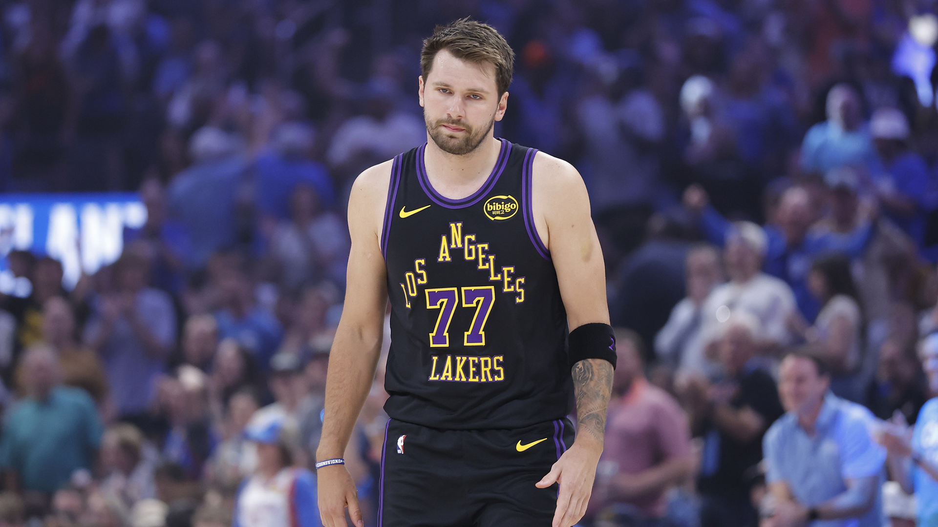 Lakers guard Luka Doncic (77) walks across the court after a play against the Oklahoma City Thunder during the first quarter at Paycom Center