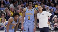 Marquette head coach Shaka Smart talks with guard Nigel James Jr. (0) and forward Damarius Owens (9) during the second half of their game Saturday, March 7, 2026 at Fiserv Forum in Milwaukee, Wisconsin. Marquette beat UConn 68-62.