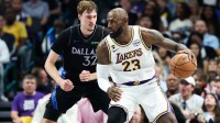 Lakers forward LeBron James (23) controls the ball as Dallas Mavericks forward Cooper Flagg (32) defends during the first half at American Airlines Center with Mavericks head coach Jason Kidd in the background