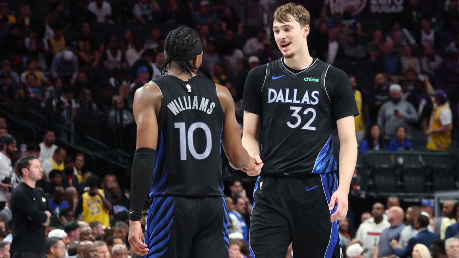 Mavericks forward Cooper Flagg (32) celebrates with Dallas Mavericks guard Brandon Williams (10) during the second half against the Los Angeles Lakers at American Airlines Center