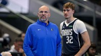 Mavericks head coach Jason Kidd and forward Cooper Flagg (32) look on