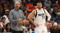 Mavericks head coach Jason Kidd with guard Luka Doncic (77) against the Phoenix Suns in the first half at Footprint Center with Mavericks' Mark Cuban in the background