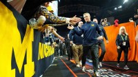 Michigan Wolverines head coach Dusty May greets fans after their win against the Arizona Wildcats in a semifinal of the Final Four of the men's 2026 NCAA Tournament at Lucas Oil Stadium.