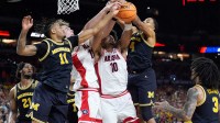 Michigan guard Nimari Burnett (4), Arizona center Motiejus Krivas (13), Arizona forward Koa Peat (10) and Michigan guard Nimari Burnett (4) reach for the ball in the first half of their Final Four game at Lucas Oil Stadium in Indianapolis on Saturday, April 4, 2026.