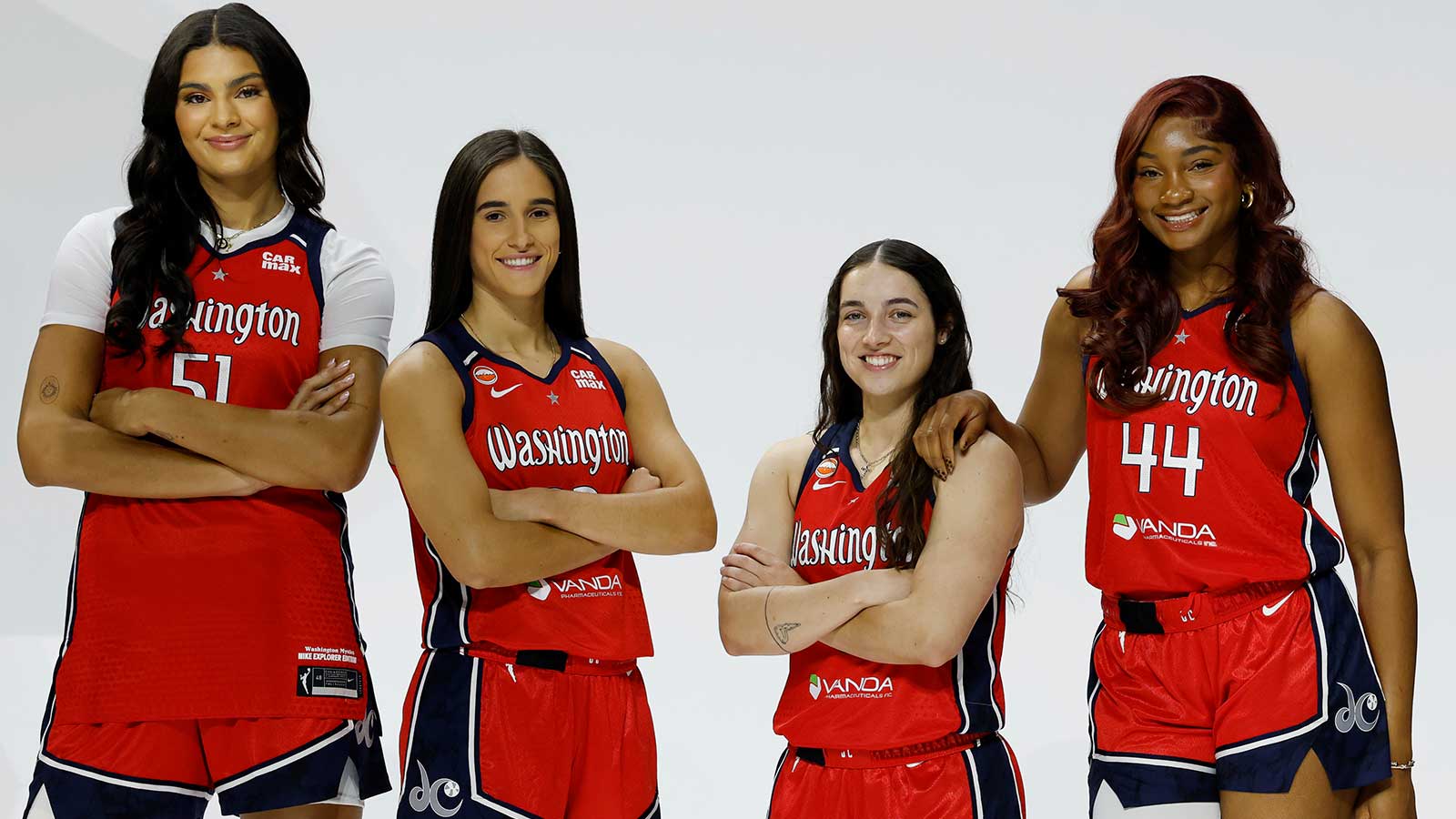(L-R) Washington Mystics center Lauren Betts (51), Mystics guard Sonia Citron (22), Mystics guard Georgia Amoore (8), and Mystics forward Kiki Iriafen (44) pose for a portrait during Mystics Media Day at CareFirst Arena.