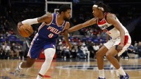 Philadelphia 76ers forward Paul George (8) drives to the basket as Washington Wizards guard Tre Johnson (12) defends in the first half at Capital One Arena.