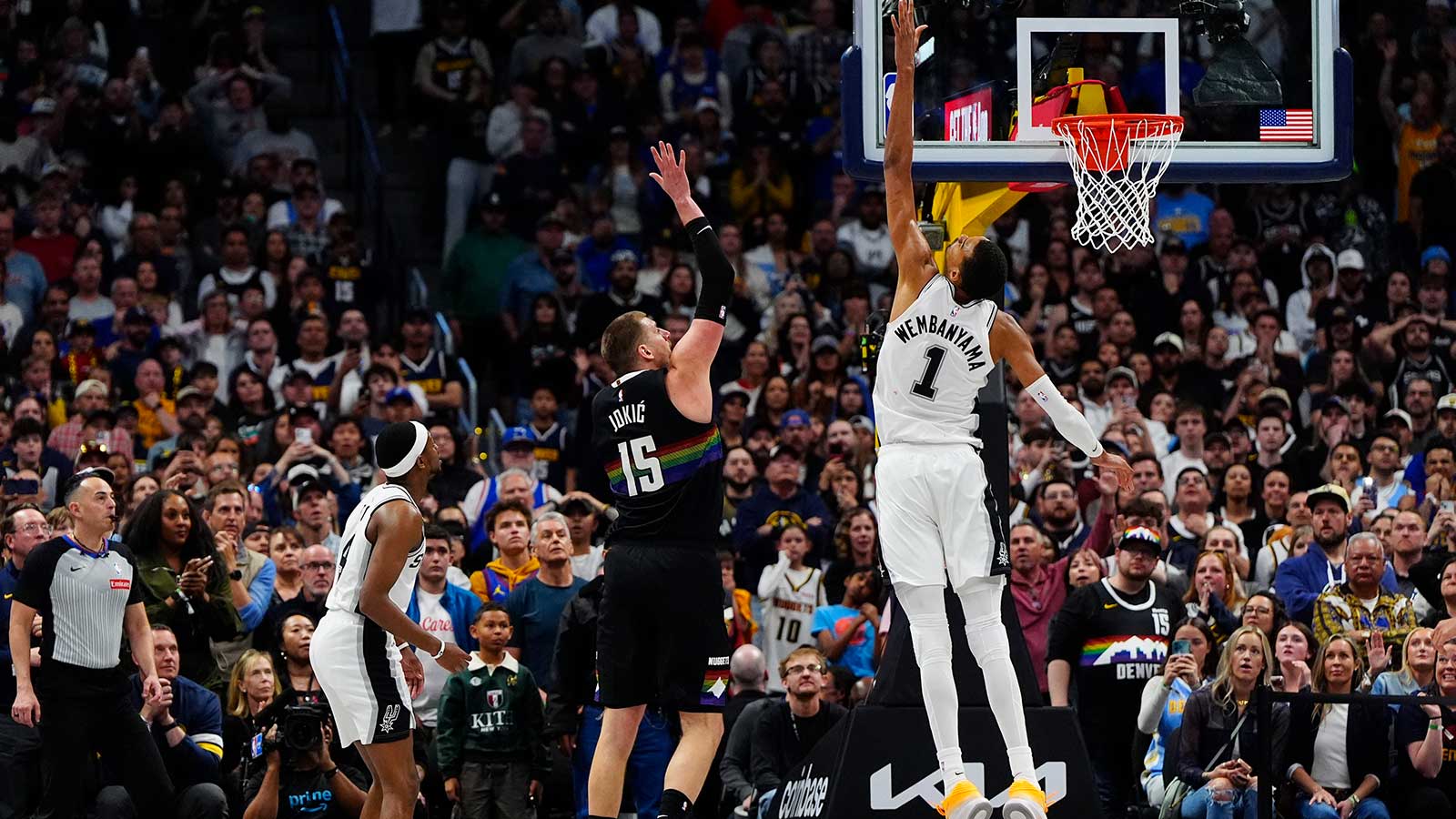 Denver Nuggets center Nikola Jokic (15) shoots the ball over San Antonio Spurs forward Victor Wembanyama (1) in overtime at Ball Arena.