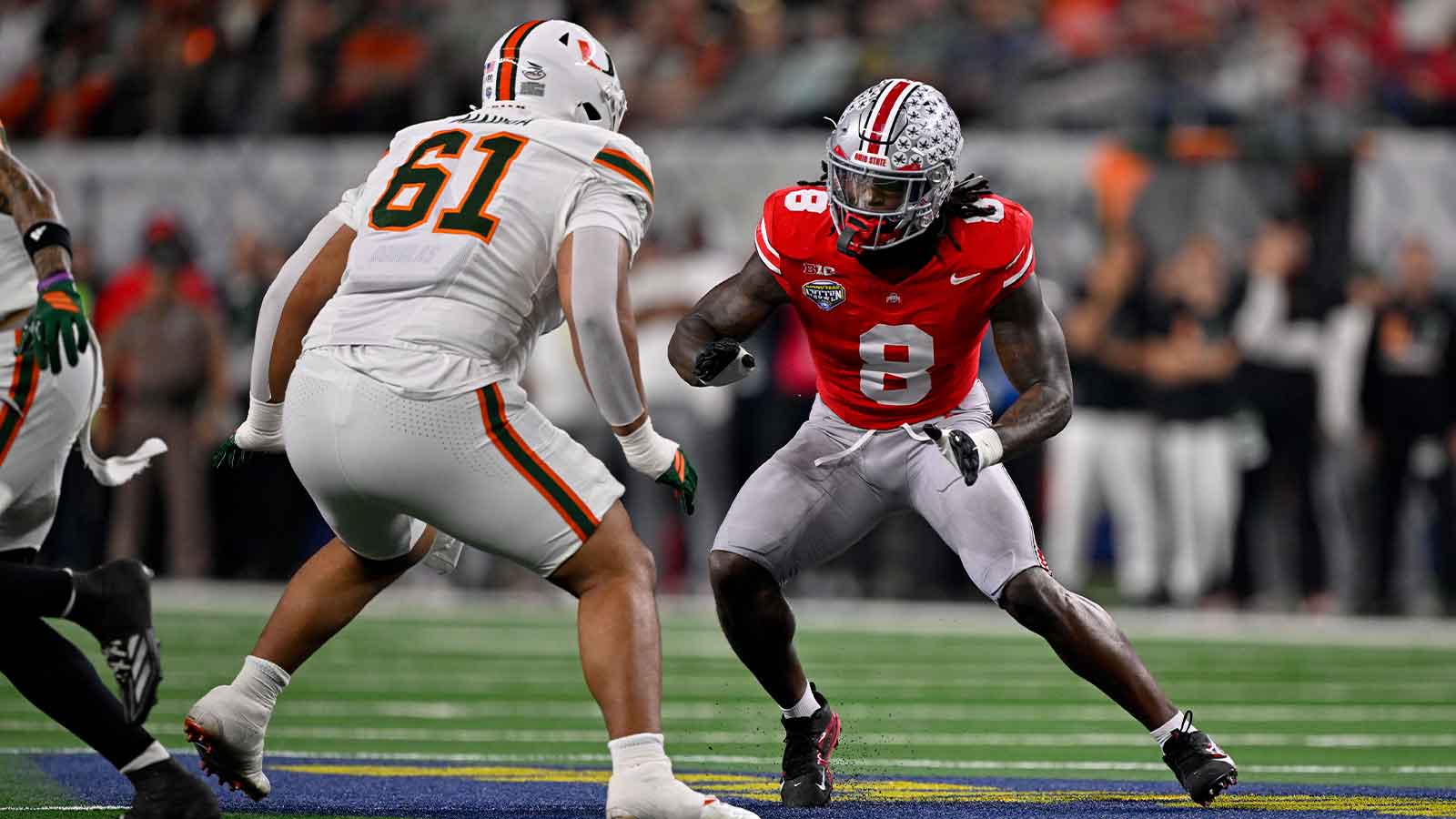 Miami Hurricanes offensive lineman Francis Mauigoa (61) blocks Ohio State Buckeyes linebacker Arvell Reese (8) during the 2025 Cotton Bowl and quarterfinal game of the College Football Playoff at AT&T Stadium.