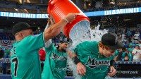 Miami Marlins right fielder Owen Caissie (17) is doused with water by center fielder Jakob Marsee (87) and catcher Agustin Ramirez (50) after hitting a two-run walk-off home run against the Colorado Rockies during the ninth inning at loanDepot Park