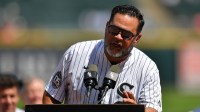 Former manager Ozzie Guillen addresses fans at the podium as the 2005 World Series Chicago White Sox are honored prior to a game against the Cleveland Guardians at Rate Field.