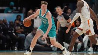Charlotte Hornets guard/forward Kon Knueppel (7) dribbles while guarded by Phoenix Suns guard Jalen Green (4) during the second half at Spectrum Center.