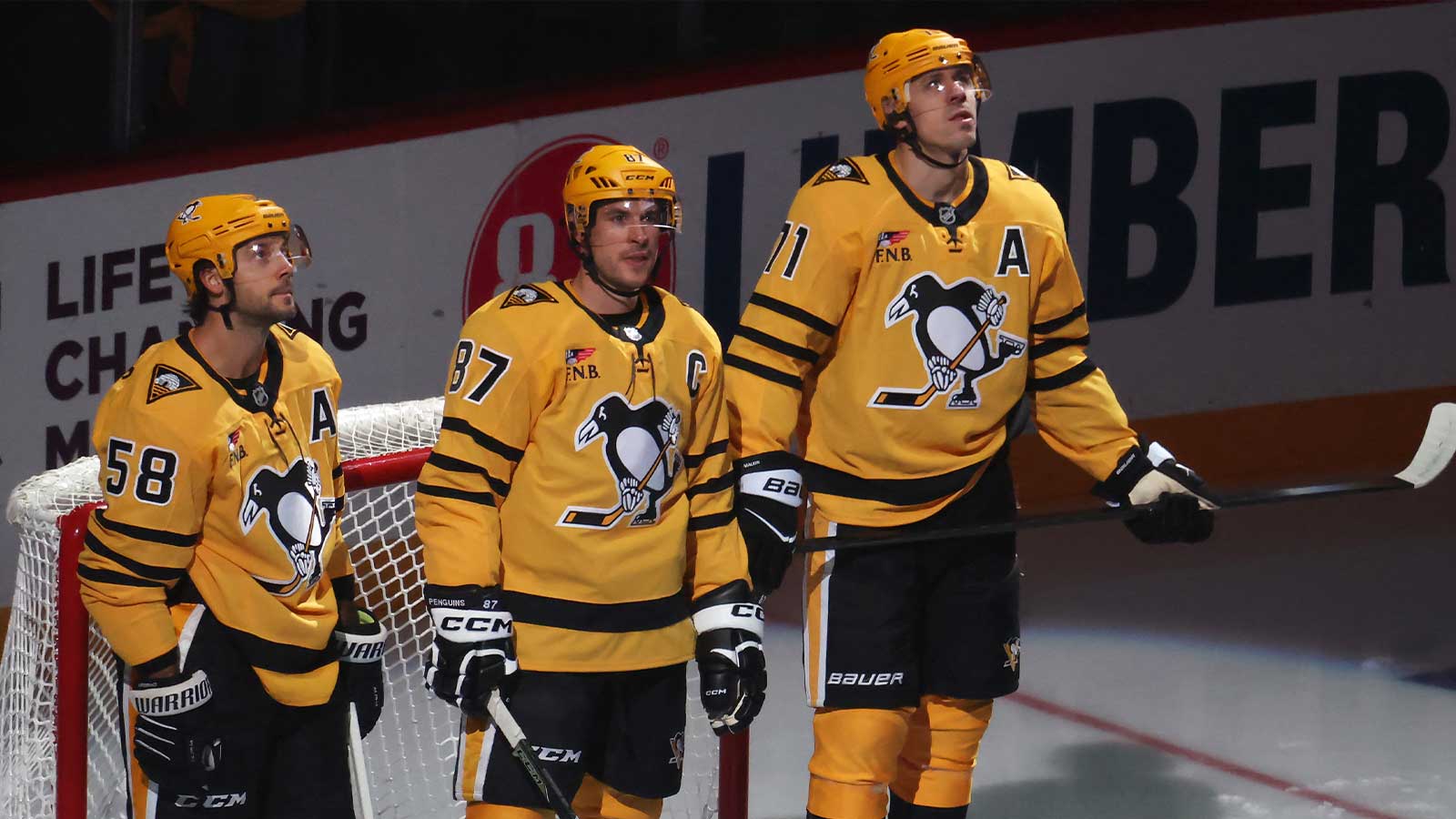 Pittsburgh Penguins defenseman Kris Letang (58) and center Sidney Crosby (87) and center Evgeni Malkin (71) stand as they are recognized as the longest tenured teammates in North American professional sports history before their twentieth season together prior to the game against the New York Islanders at PPG Paints Arena.