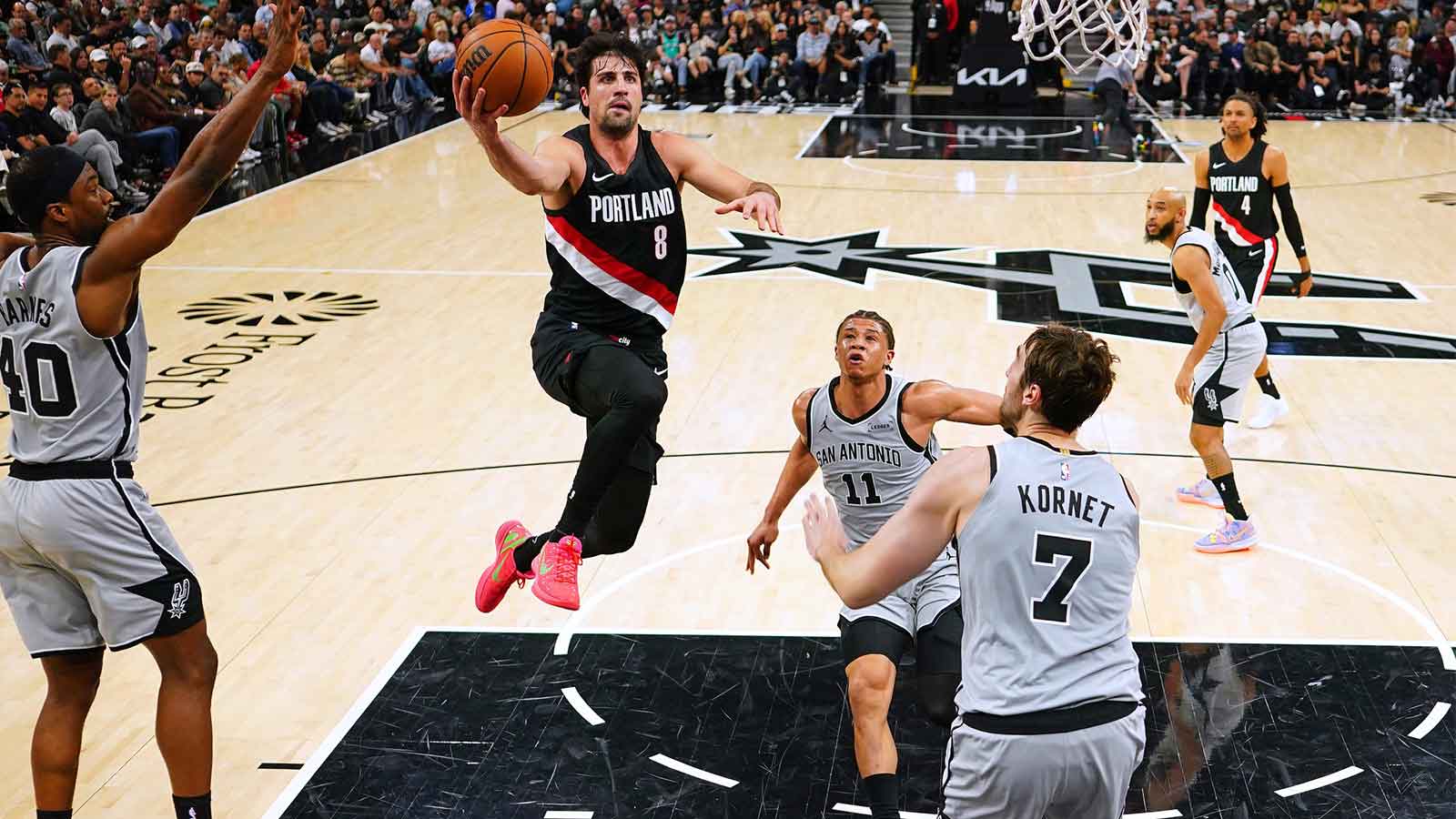 https://wp.clutchpoints.com/wp-content/uploads/2026/04/Portland-Trail-Blazers-forward-Deni-Avdija-8-drives-to-the-basket-between-San-Antonio-Spurs-forwards-Carter-Bryant-11-and-Harrison-Barnes-40-and-center-Luke-Kornet-7-during-the-first-half-at-Frost-Bank-Center-2.jpg