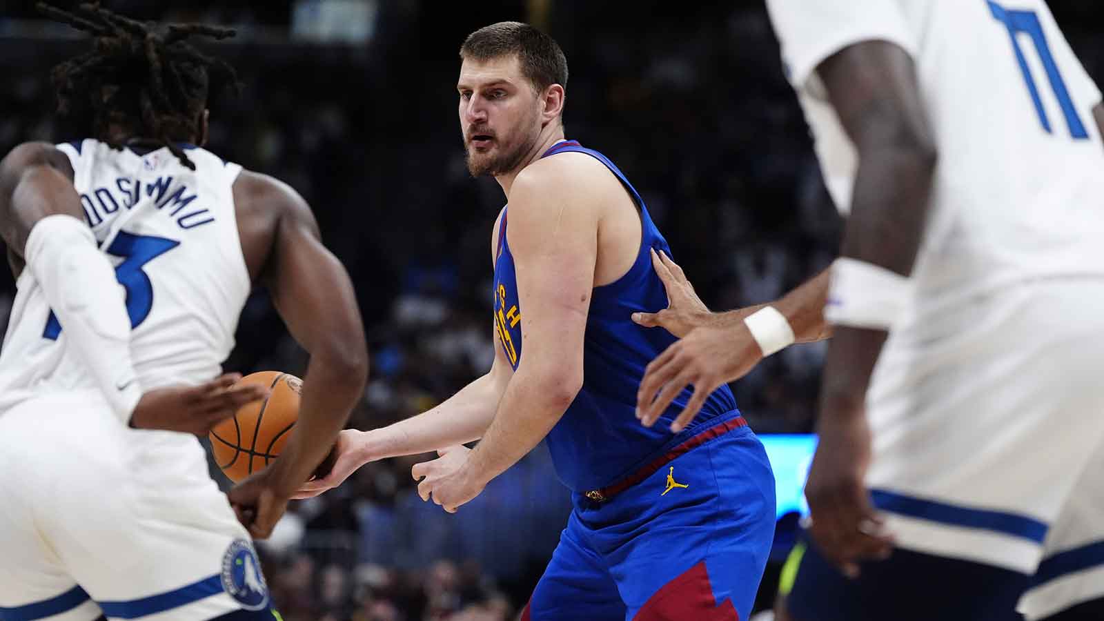 Denver Nuggets center Nikola Jokic (15) passes the ball in the second half against the Minnesota Timberwolves at Ball Arena. 
