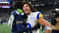 Seattle Seahawks cornerback Riq Woolen (27) and Los Angeles Rams wide receiver Puka Nacua (12) embrace after the 2026 NFC Championship Game at Lumen Field.