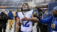 Los Angeles Rams wide receiver Puka Nacua (12) gives his wristband to a fan as he leaves the field after an NFC Divisional Round game against the Chicago Bears at Soldier Field.