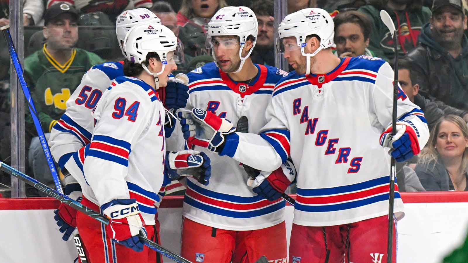 New York Rangers forward Noah Laba (42) celebrates his power play goal against the Minnesota Wild with forward Gabe Perreault (94), forward Will Cuylle (50), and defensemen Vladislav Gavrikov (44) during the first period at Grand Casino Arena.