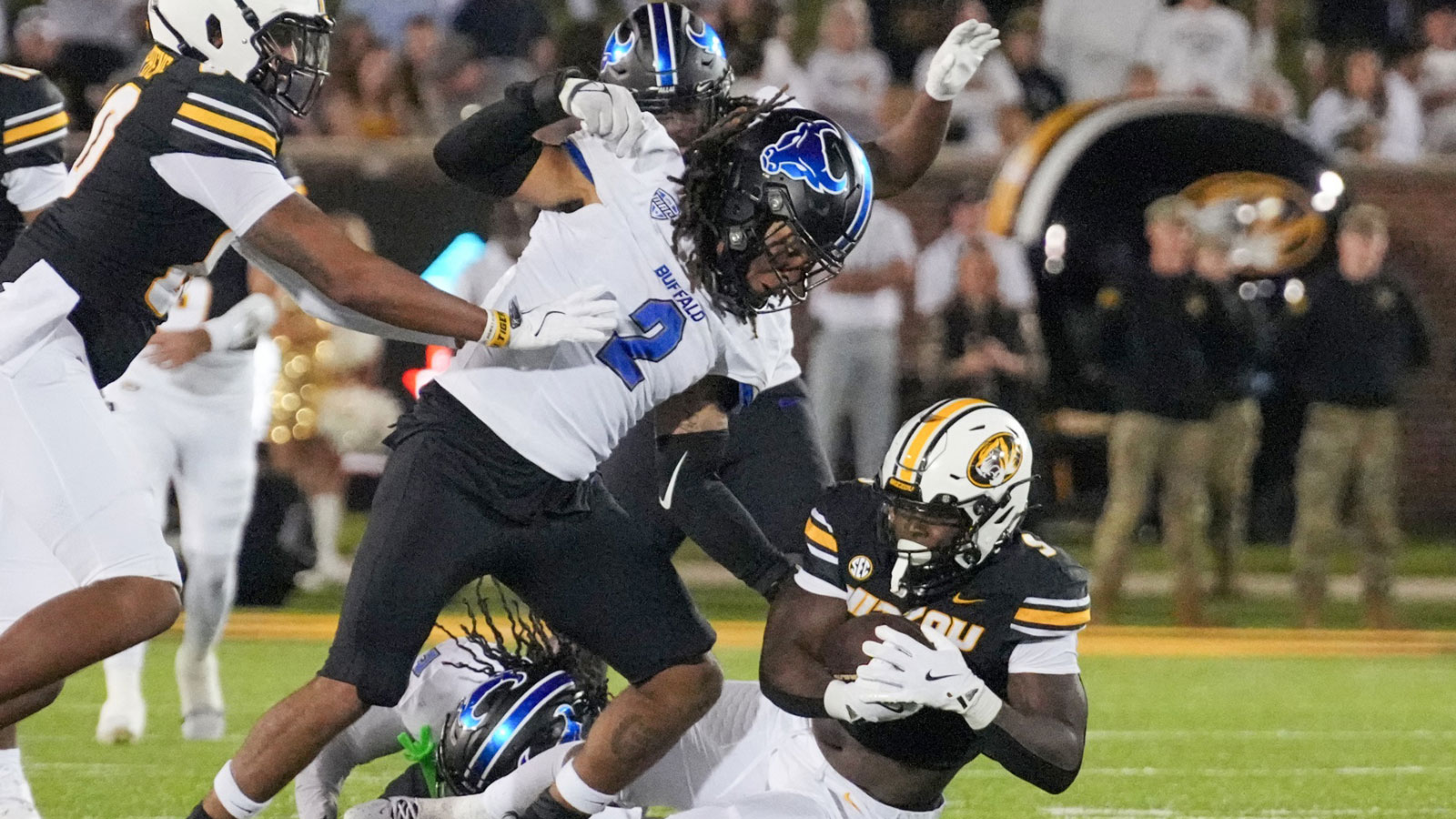 Missouri Tigers running back Marcus Carroll (9) runs the ball as Buffalo Bulls linebacker Red Murdock (2) attempts the tackle during the second half at Faurot Field at Memorial Stadium. 