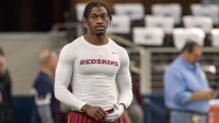 Washington Redskins quarterback Robert Griffin III (10) warms up before the game against the Dallas Cowboys at AT&T Stadium. The Redskins defeat the Cowboys 34-23.