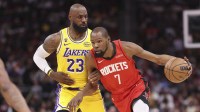 Rockets forward Kevin Durant (7) dribbles the ball as Los Angeles Lakers forward LeBron James (23) defends during the first quarter at Toyota Center
