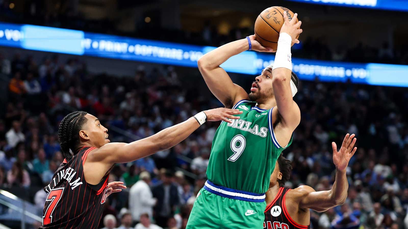 Dallas Mavericks guard Ryan Nembhard (9) shoots as Chicago Bulls guard Rob Dillingham (7) defends during the second half at American Airlines Center.