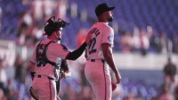 Miami Marlins starting pitcher Sandy Alcantara (22) reacts following his complete game shutout win over the Chicago White Sox by catcher Liam Hicks (34) at loanDepot Park.