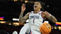 UConn Huskies guard Solo Ball (1) dunks against the Illinois Fighting Illini during the second half of a semifinal of the Final Four of the men's 2026 NCAA Tournament at Lucas Oil Stadium.